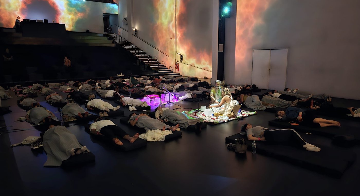 Sound Therapy Ceremony with Hind and Mr. Dervish, participants lying on mats among singing bowls